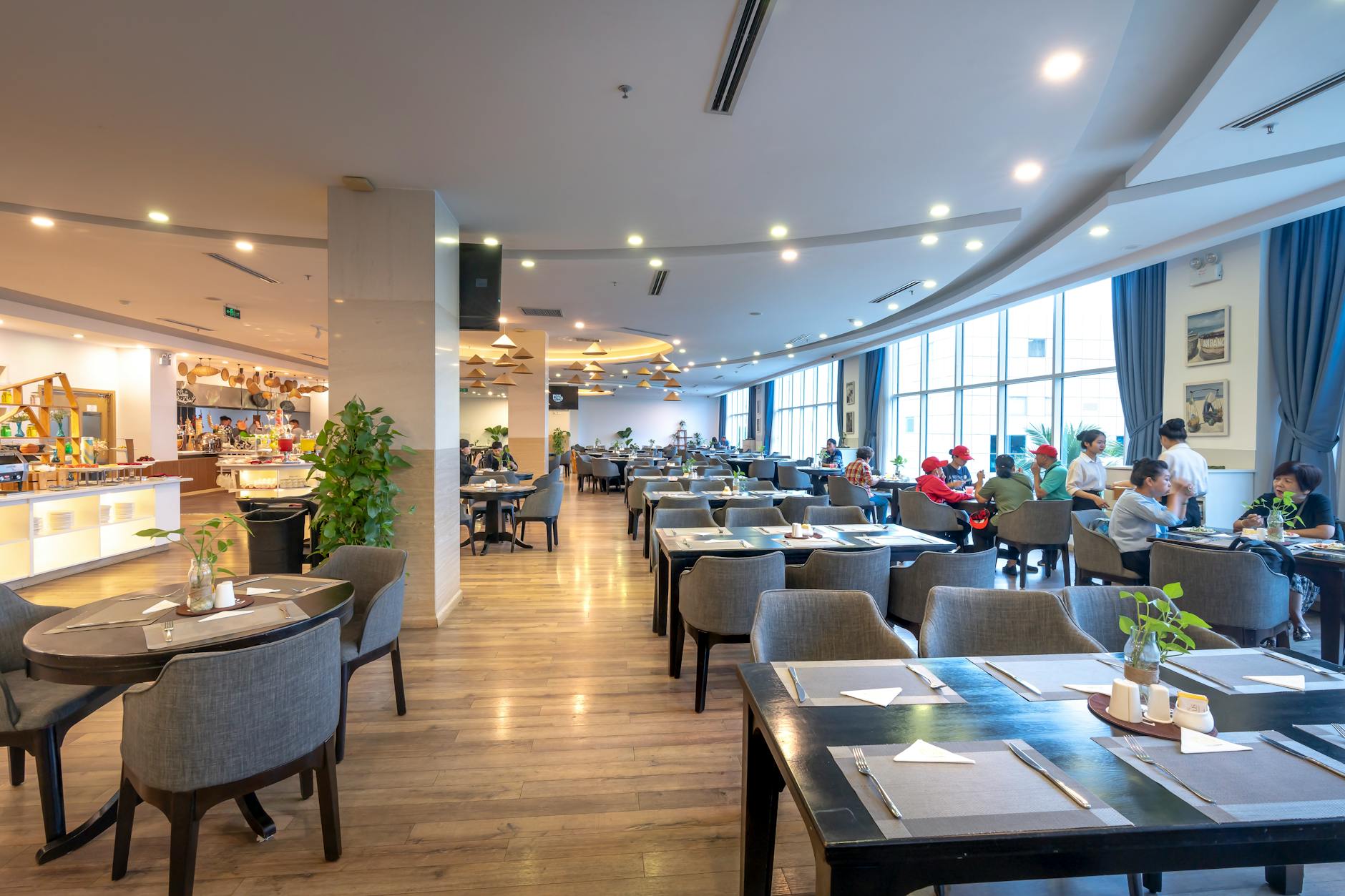Spacious restaurant interior with guests dining and modern decor