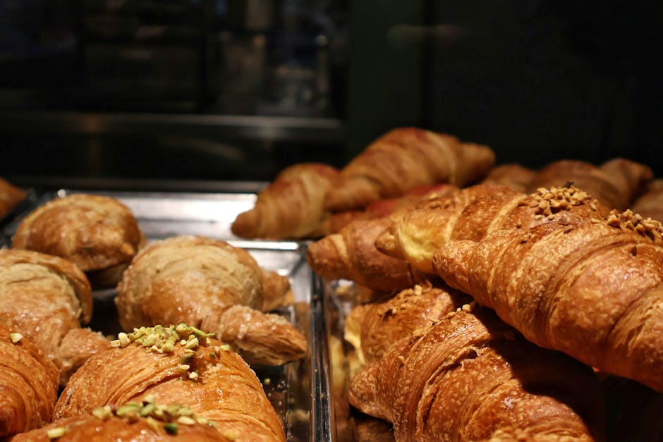 Fresh croissants in a bakery display case for food-service signage ideas