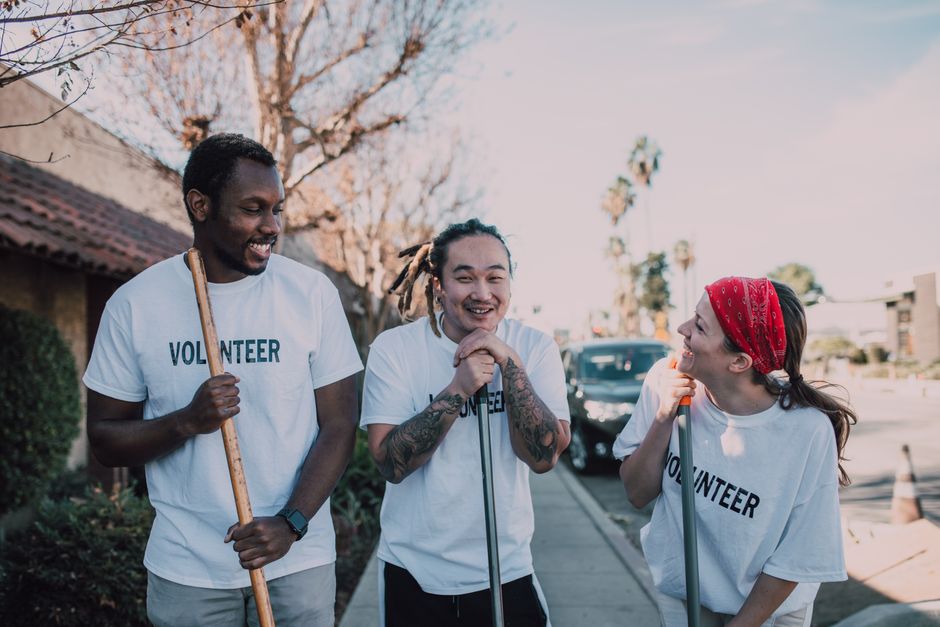 Three community volunteers preparing for a service project