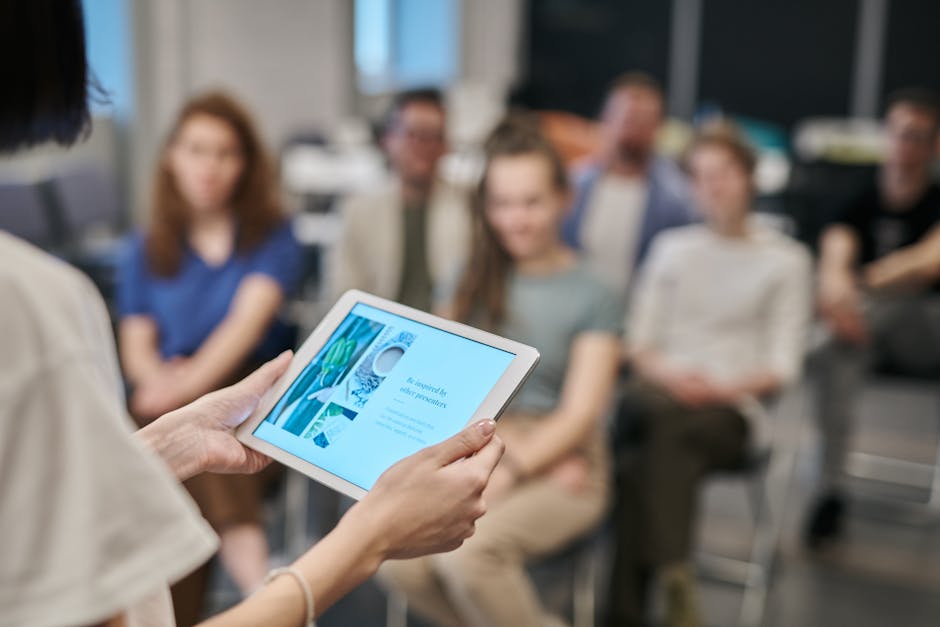 Employee reading from a tablet during an office planning session