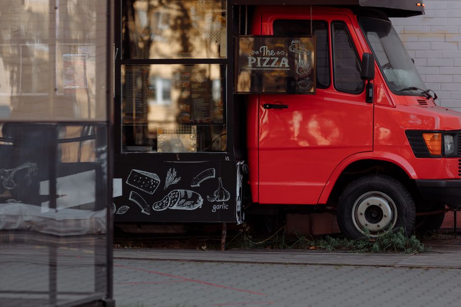 Red food truck exterior with a visible menu window and service area