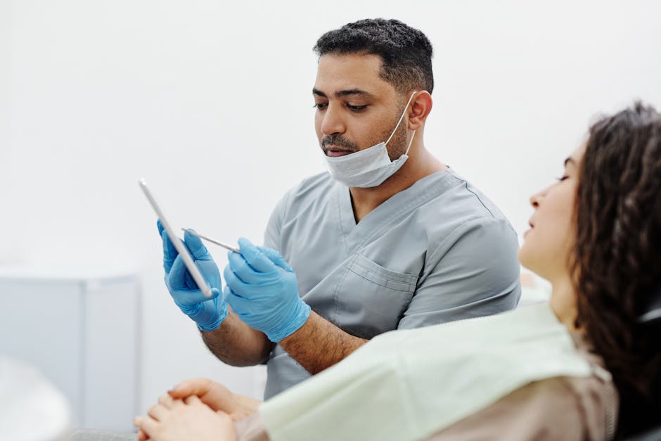 Clinician using a tablet during a patient consultation