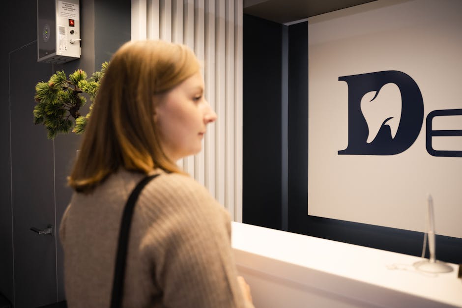 Patient standing at a dental office reception counter