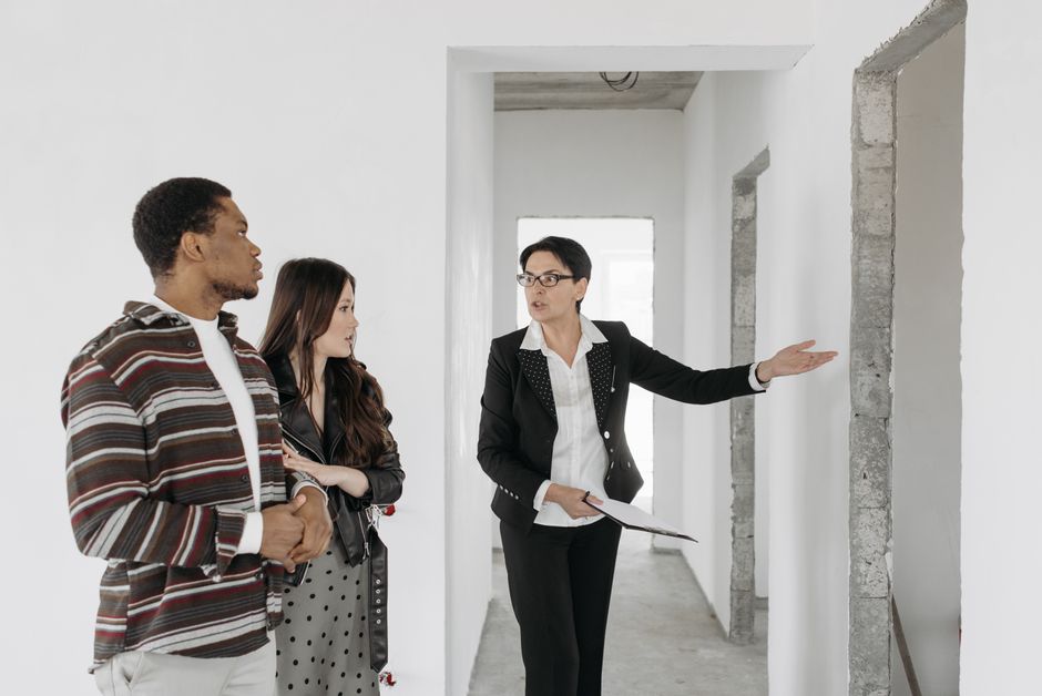 Real estate agent showing an apartment to two prospective buyers