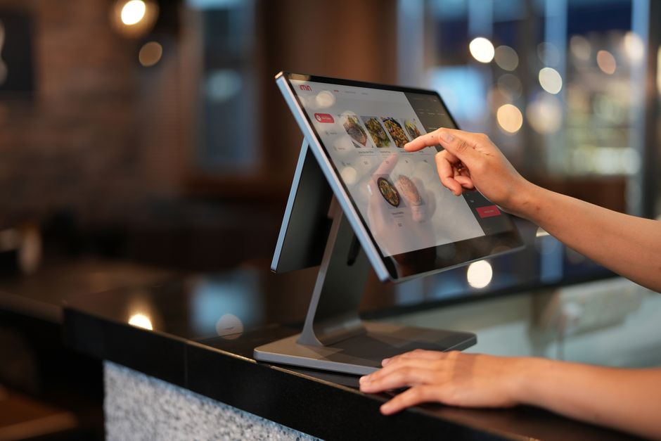 Restaurant POS touchscreen used to plan signage playback hardware
