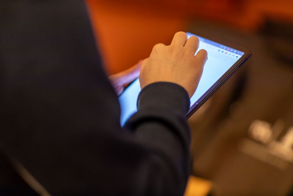 Person editing content on a handheld tablet