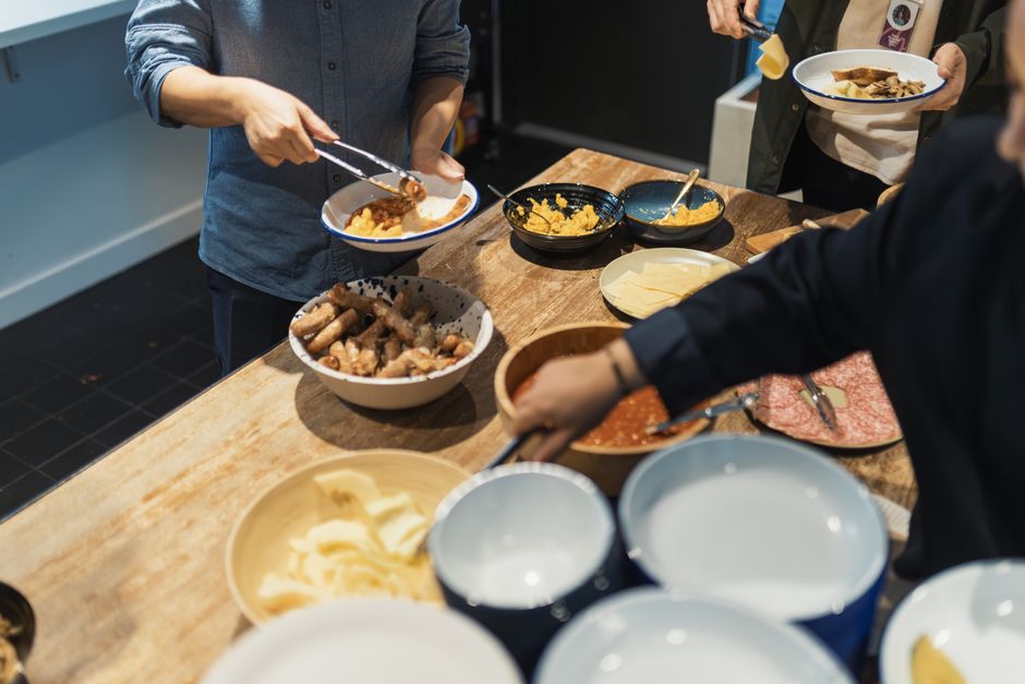 Guests serving dishes at a buffet table