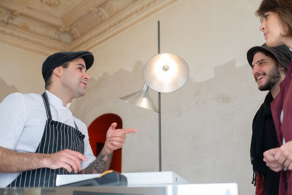 Clientes revisando promociones en un restaurante para comparar ventas antes y después