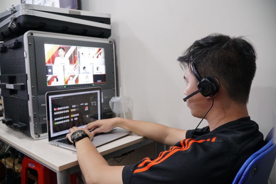 A technician managing several video feeds from a compact control station
