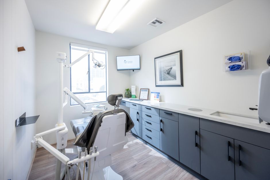 A dental treatment room with a wall-mounted information screen