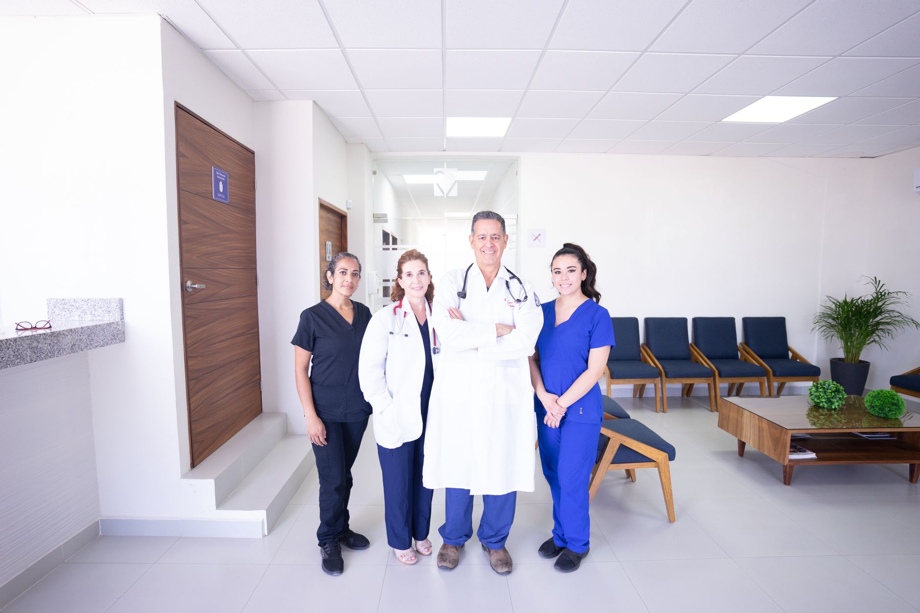 A healthcare team standing in a bright clinic waiting area