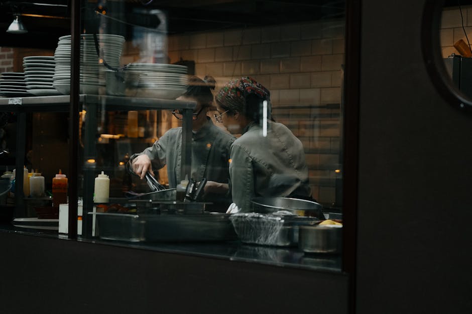 Restaurant kitchen team preparing meals during service